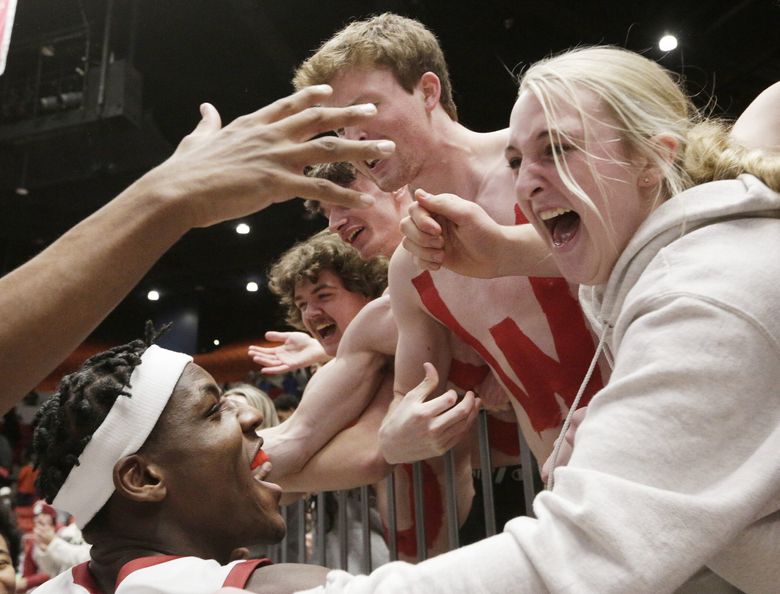 Washington State center Rueben Chinyelu, bottom left, celebrates with fans after a win over Arizona in an NCAA college basketball game, Saturday, Jan. 13, 2024, in Pullman, Wash. (Young Kwak / The Associated Press)